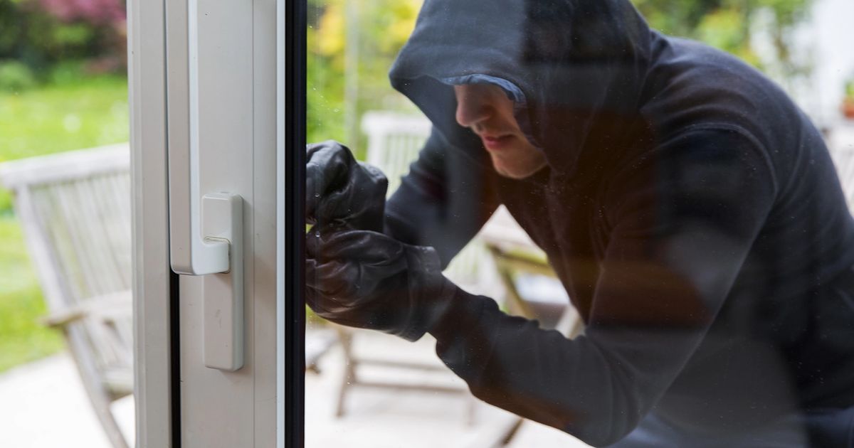 Burgler entering the house.